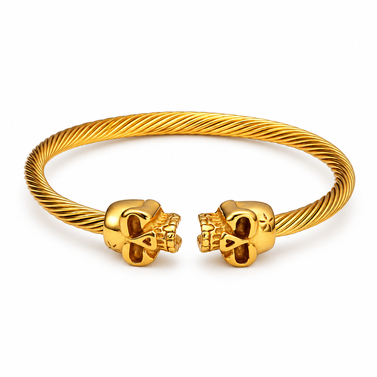 Open Cuff Skull Bracelet — gold finish with twin skull ends and textured band, on a white background