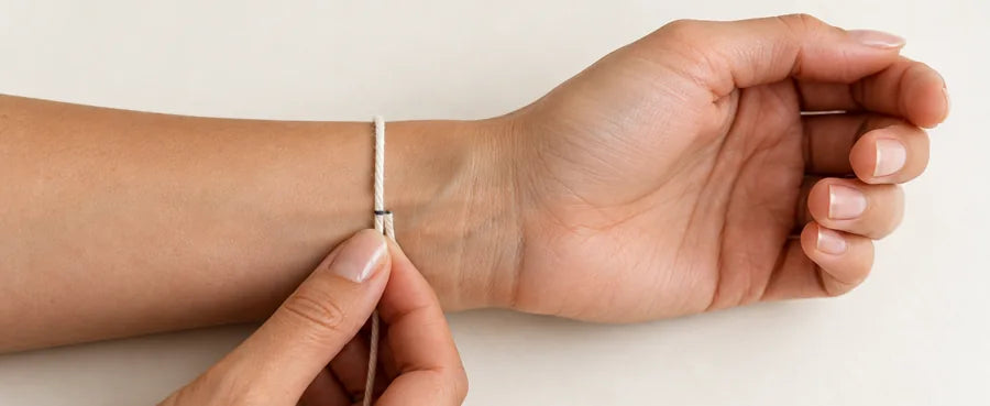A piece of string wrapped around the wrist above the wrist bone.